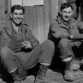 Two men sitting in front of the 1st Plt Co H  179INF CP