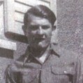 Unidentified soldier in front of building